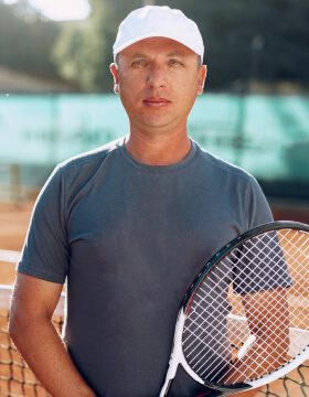 middle-aged-man-tennis-player-with-racket-standing-2021-09-03-12-46-25-utc.jpg